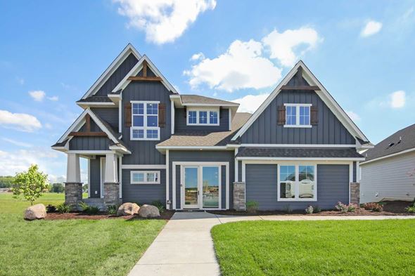 Lake Elmo house for rent - A modern house with a grey exterior and a stone pillar at the entrance.