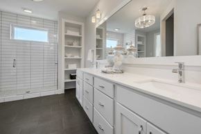Lake Elmo house for rent - A modern bathroom with a large mirror and a walk-in shower.