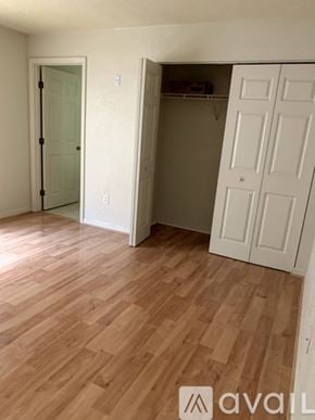 Ocala house for rent - A room with a white door and a white closet with wood flooring.