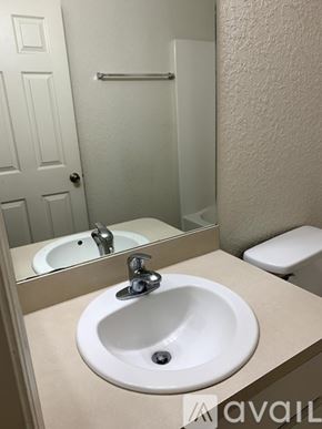Ocala house for rent - A white sink in a bathroom with a mirror above it.