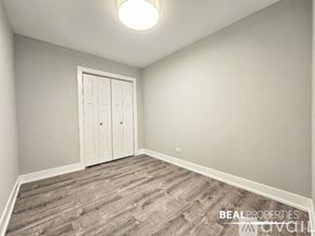 Chicago condo for rent - A bathroom with a tub, toilet, and sink.