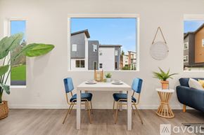 Monroe townhouse for rent - A dining room with a white table and blue chairs.
