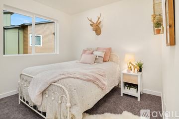 Monroe townhouse for rent - A bedroom with a large bed and a deer head mounted on the wall.