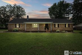 Athens house for rent - A house with a brick facade stands in a grassy yard.