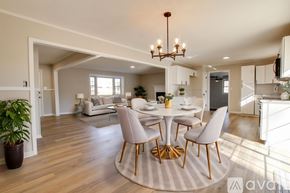 Athens house for rent - A spacious living room with wooden flooring and a chandelier.
