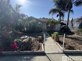 Compton house for rent - A sunny day in a residential area with a house and a garden.