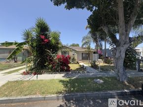 Compton house for rent - A residential area with a house, palm trees, and a street.
