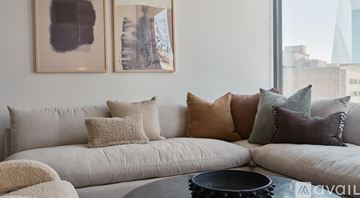 Dallas apartment for rent - A living room with a large couch and two framed pictures on the wall.