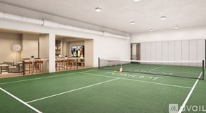 Dallas apartment for rent - A tennis court is located in a spacious room with a white ceiling and walls.