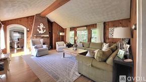 Wells house for rent - A living room with a couch, chairs, and a rug.