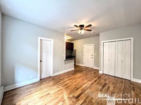 Chicago apartment for rent - A room with wood flooring and a door on the left side.