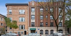 Chicago apartment for rent - A large brick building with a green awning and the words "Beal Properties" on the front.