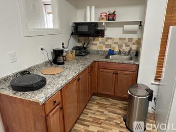 Henderson apartment for rent - A kitchen with wooden cabinets and granite countertops.
