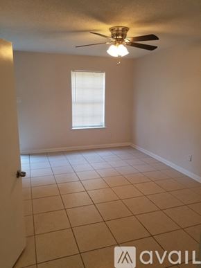 New Orleans apartment for rent - A room with a ceiling fan and a window.