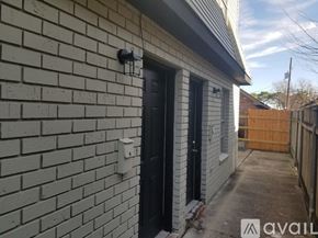 New Orleans apartment for rent - A house with a black door and a white wall.