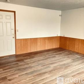 La Crosse apartment for rent - A room with wooden flooring and a white door.