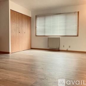 La Crosse apartment for rent - A room with wooden floors and a television set.