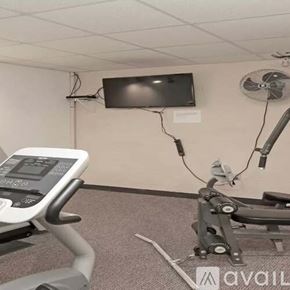La Crosse apartment for rent - A treadmill and a television are in a room.