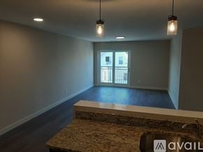 Lowell apartment for rent - A two-story house with a blue exterior and white trim.