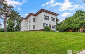 Elgin apartment for rent - A house with a porch and a sign that says "available" in the front yard.