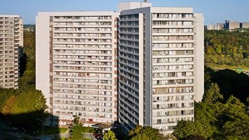 Toronto apartment for rent - A large, grey apartment building with a lot of windows and balconies.