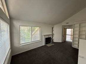 Boulder apartment for rent - A living room with a fireplace and a window with blinds.