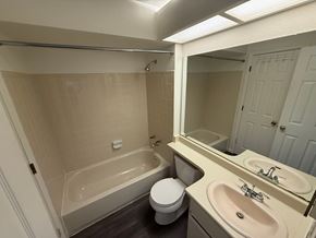 Boulder apartment for rent - A white bathroom with a toilet, sink, and bathtub.