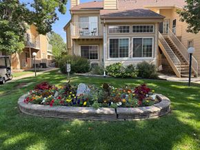 Boulder apartment for rent - A flower bed in front of a two-story apartment building.