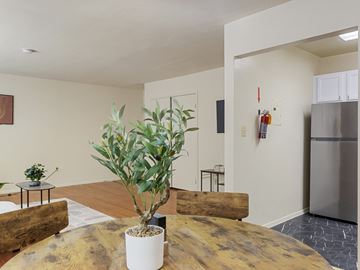 Washington apartment for rent - A living room with a wooden table and a plant on it.