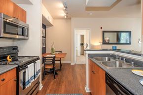 Sacramento apartment for rent - A kitchen with a stove top oven and microwave.