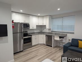 State College apartment for rent - A modern kitchen with stainless steel appliances and a wooden floor.