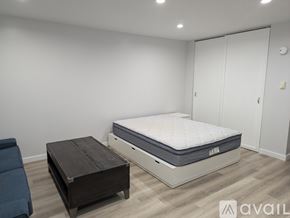 State College apartment for rent - A bedroom with a bed, a mattress, and a wooden coffee table.
