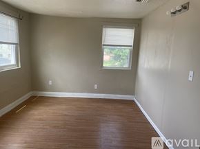 Orlando apartment for rent - A room with wooden flooring and a window with blinds.