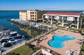 St. Augustine apartment for rent - A marina with boats docked in front of a building with a pool.