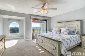 St. Augustine apartment for rent - A bedroom with a large bed and a ceiling fan.