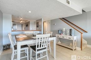 St. Augustine apartment for rent - A dining room with a wooden table and chairs.