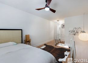 Miami apartment for rent - A bedroom with a large bed and a cowhide rug.