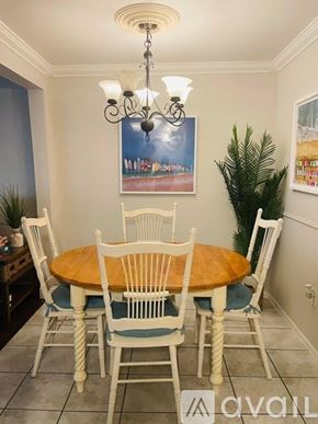 St. Petersburg house for rent - A dining room with a wooden table and chairs.