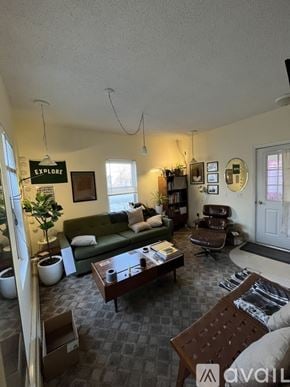 Traverse City apartment for rent - A living room with a green couch, a wooden coffee table, and a sign that says "Explore".