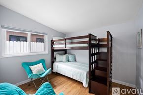 Ventura house for rent - A bedroom with a bunk bed and a chair.