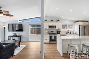 Ventura house for rent - A modern kitchen with white cabinets and stainless steel appliances.
