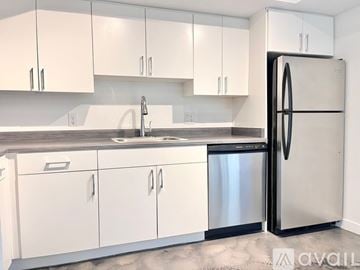 Phoenix apartment for rent - A kitchen with white cabinets and a black refrigerator.