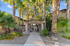 Wickenburg apartment for rent - A beautifully landscaped entrance to a condo complex with a clear blue sky above.