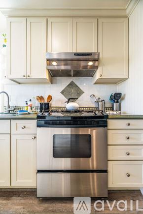 Ventura house for rent - A kitchen with a stove top oven and a range hood above it.