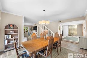 Ventura house for rent - A dining room with a wooden table and chairs.