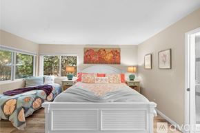 Ventura house for rent - A bedroom with a large bed and a painting on the wall.