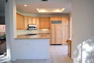 Camarillo house for rent - A kitchen with wooden cabinets and a white island.