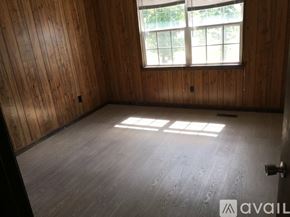 Cleveland apartment for rent - A room with wooden walls and floor and a window.