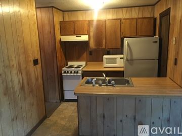 Cleveland apartment for rent - A kitchen with wooden cabinets and a stove top oven.