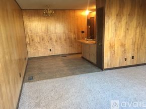 Cleveland apartment for rent - A room with wooden walls and a bathroom area with a sink and mirror.